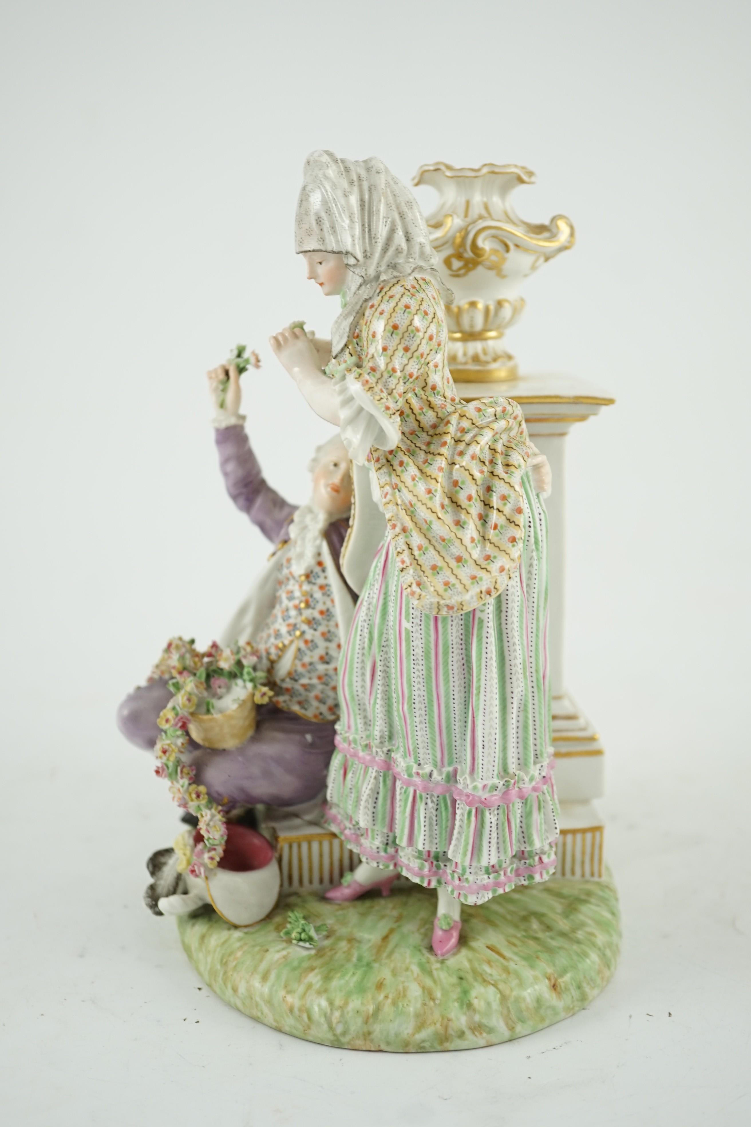 A Meissen porcelain group of a maid and a gallant by a pedestal, 19th century, 22cm high, crack to base